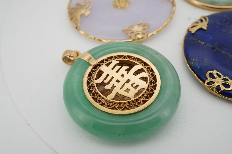 A collection of Chinese jewels, including three disc shaped pendants in pale lavender and green jadeite, mounted in gold, longest 4.6cm including bail; another disc-shaped pendant in lapis lazuli, mounted in gold; and a